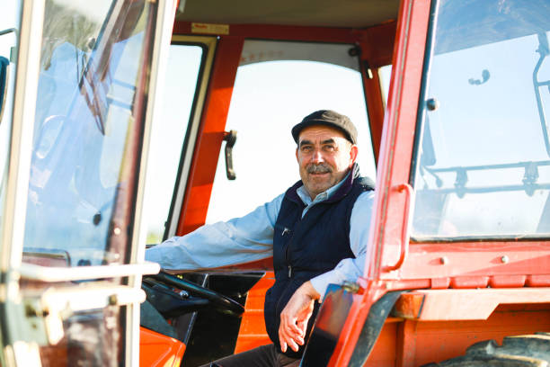 istock senior farmer drives tractor in the field 1491450667