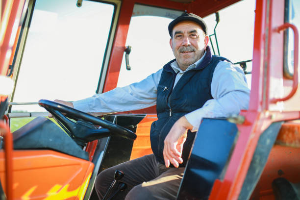 istock senior farmer drives tractor in the field 1491450732