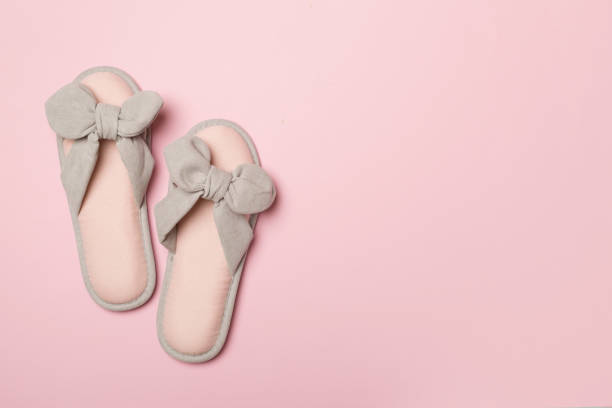 istock Soft pink slippers on color background, top view 1491451625