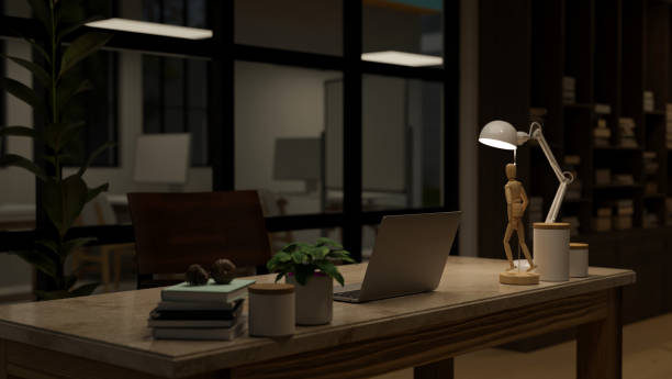 istock Interior design of a modern office at night with laptop and decor on a table. 1491453348