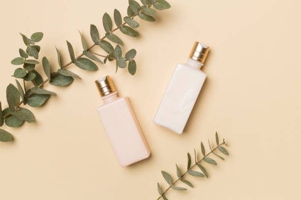 istock Cosmetic bottles with eucalyptus branch on color background, top view 1491453381