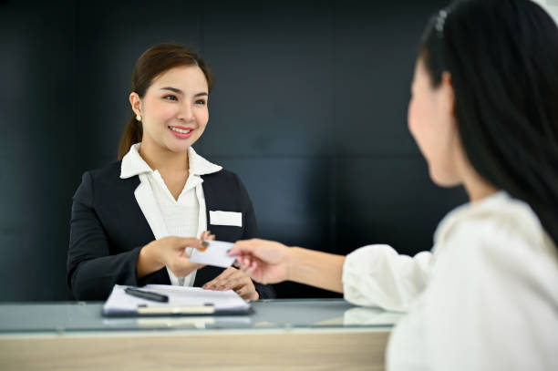 istock Friendly Asian female receptionist greeting and welcoming a customer with beautiful smile 1491453734