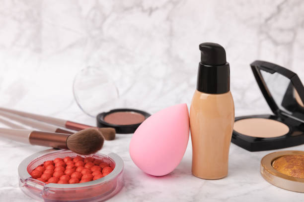 istock Beauty blender in foundation, concealer composition on white marble background. Makeup artist concept, copy space. 1491454610
