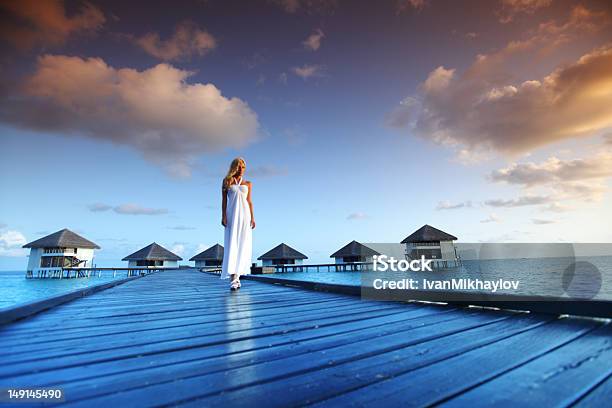 Woman In A Dress On Maldivian Sunset Stock Photo - Download Image Now - Adult, Adults Only, Beautiful Woman