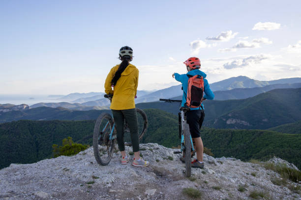 istock Young women pause on mountain top with bicycles 1491456318