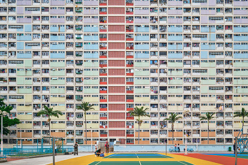 Hong Kong SAR, China - April 2023: Choi Hung Estate and basketball courts, colourful facades of a dense public Housing in Kowloon