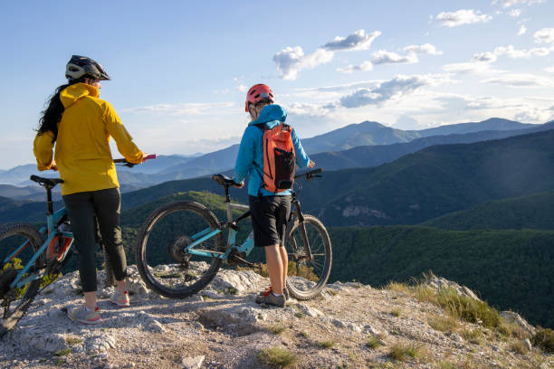 istock Young women pause on mountain top with bicycles 1491456609