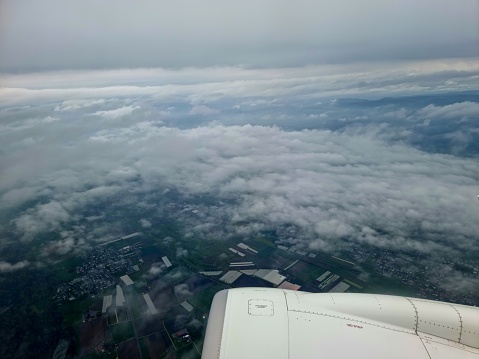 Clouds and fields seen from an aircraft. The image was captured during spring season.