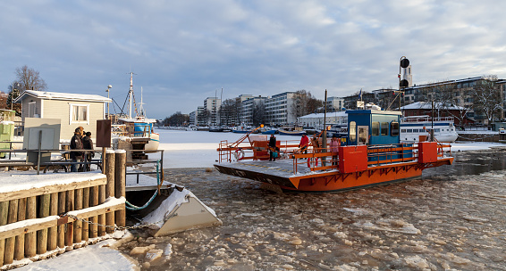 Turku, Finland - January 22, 2016: City boat Fori with passengers is on the way. This is a light traffic ferry that has served the Aura River for over a hundred years, first taking passengers in 1904