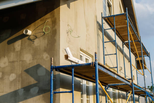 istock House insulation concept. Facade insulation with mineral wool, thermal improvement and energy saving. Modern farmhouse renovation, scaffolding platform and stone wool covered with plaster 1491459407