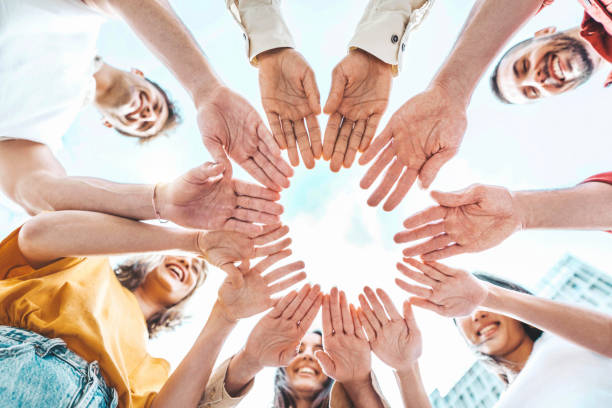 istock Group of young people stacking hands outdoors - Teamwork concept with guys and girls support each other - College students standing together outside 1491459615