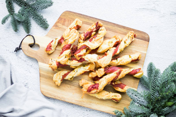istock Puff pastry sticks. Close-up of puff pastry with prosciutto. 1491461502