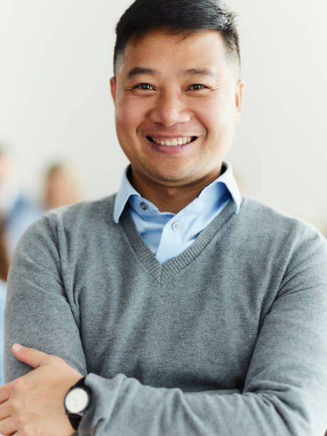 istock Happy Asian businessman with crossed arms. 1491462848