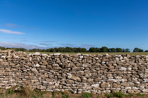 Frontal view of the limestone dry-stone walls over Lansdowne Hill in the Cotswolds as used as a defense where The First English Civil War battle of Lansdown was fought on 5 July 1643