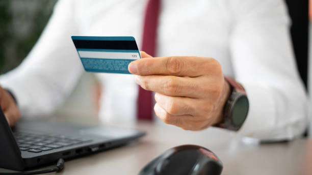 istock Businessman using credit card together with laptop in office 1491463449