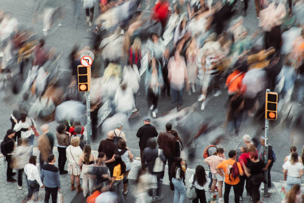 istock Crowd of people walking at zebra crossing. 1491464421