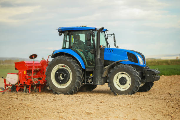istock young farmer planting corn in the field with tractor and seeder 1491464618
