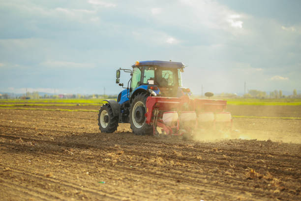 istock young farmer planting corn in the field with tractor and seeder 1491464644