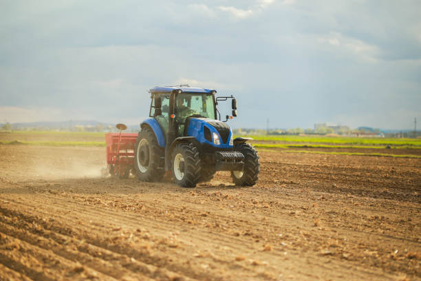 istock farmer planting corn in the field with tractor and seeder 1491464720