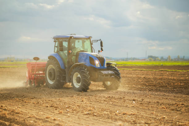 istock farmer planting corn in the field with tractor and seeder 1491464763