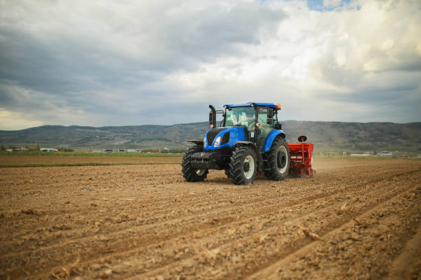 istock farmer planting corn in the field with tractor and seeder 1491464836