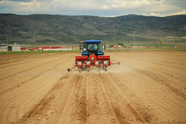 istock young farmer sowing seeds with satellite system in the prepared field 1491464934