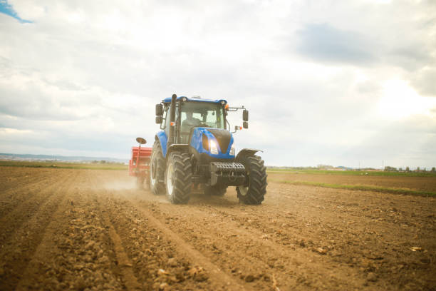 istock farmer planting seeds with tractor and seeder 1491464944