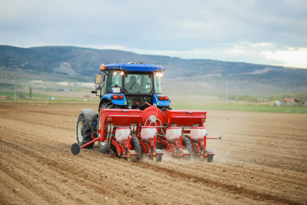 istock farmer planting corn in the field with tractor and seeder 1491465061