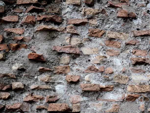 Ancient brick wall background. Colosseo vintage wall. Texture of old amphitheater stone useful for design.