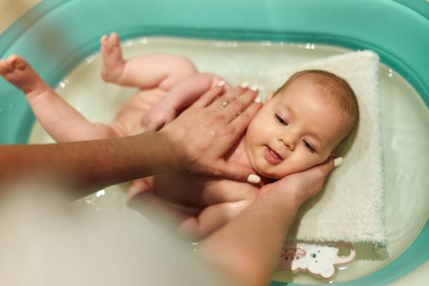 istock Unrecognizable mother bathing her baby girl. 1491467246