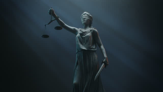 Cinematic and Atmospheric Shot of Lady Justice Sculpture. The Statue is Blindfolded and Holding Scales and Sword.
A Title Sequence for Court Show Mock-up.