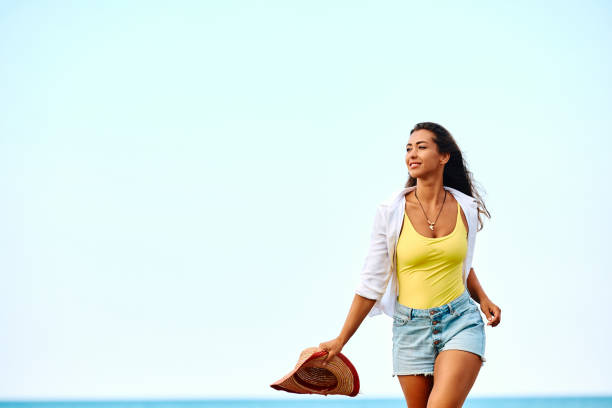 istock Young woman on the beach against the sky. 1491468456