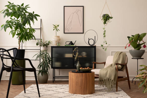 istock Creative composition of living room interior with mock up poster frame, black sideboard, round coffee table, stylish armchair, plants in flowerpots and personal accessories. Home decor. Template. 1491469090