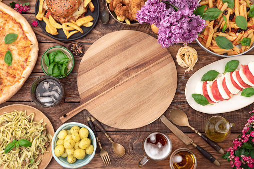 Food with cutting board on table. Top view