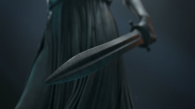 Cinematic and Atmospheric Close-up Shot of a Sword in Hand of Lady Justice Statue. A Glare of Light Passes over the Sword.
A Opening Sequence for Court Show Mock-up.