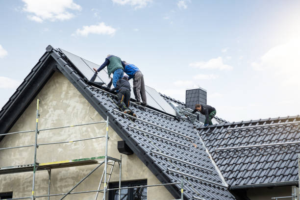 Workers installing solar panels on the roof of a German single family home stock photo