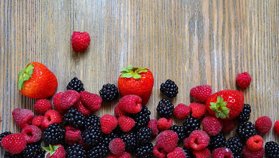 fresh berries on wooden background summer concept food closeup