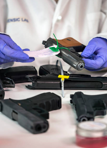 istock Police scientist notes serial number on sealed firearm in crime lab, conceptual image 1491476605