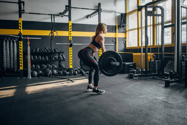 istock Young woman weightlifting in gym 1491479607