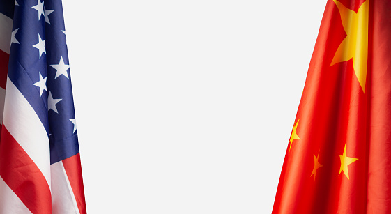 The American and Chinese flags over a white background. Space for text