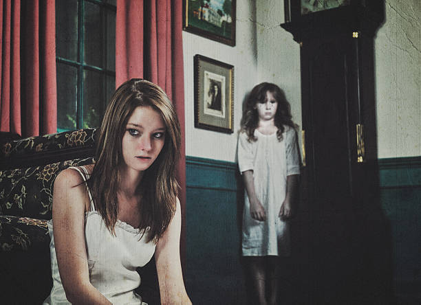 Ghost in the Corner A bizarre scene in a historic mansion of a teenage girl in the foreground with a ghostly young girl crying blood in the corner. colonial style photos stock pictures, royalty-free photos & images