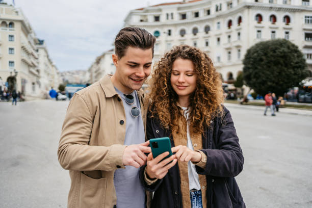 istock Young Couple Using Phone On The Aristotelous Square In Thessaloniki 1491484916