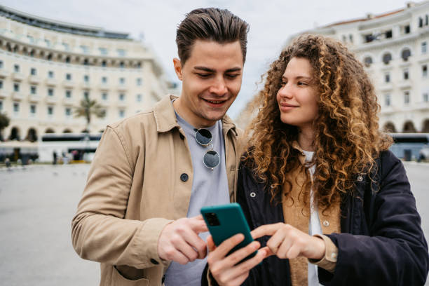 istock Young Couple Using Phone On The Aristotelous Square In Thessaloniki 1491485746