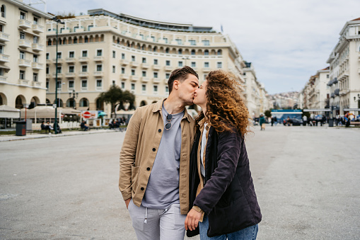 Young couple kissing on the Aristotelous (Aristotle) square in Thessaloniki, Greece.