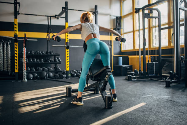 istock Fit woman training with dumbbells 1491486374