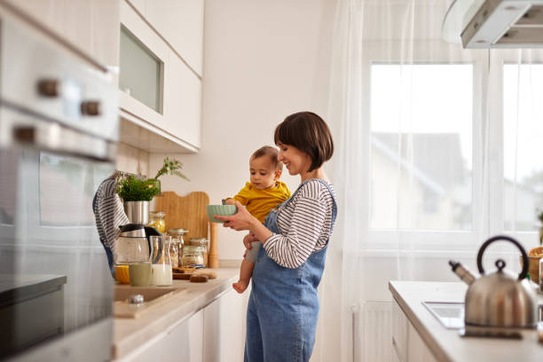 istock Mother and baby boy in the kitchen preparing breakfast 1491487642