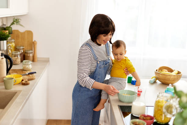 istock Mother and baby boy in the kitchen preparing breakfast 1491487704
