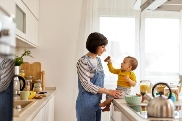 istock Baby boy feeding his mother in the kitchen 1491487956