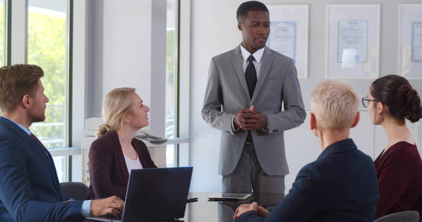 istock Afro-american male business coach training successful team in office 1491488840