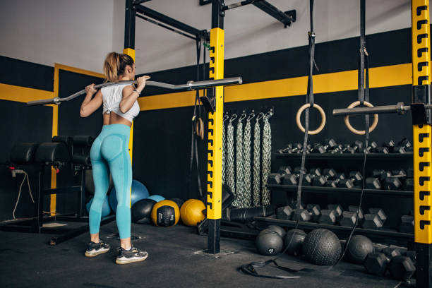 istock Young woman exercising in gym 1491489577